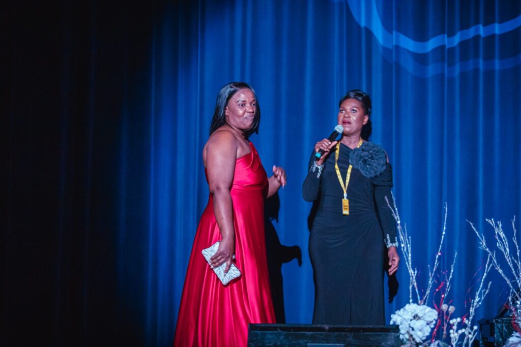 Guests in formal wear on the red carpet stage